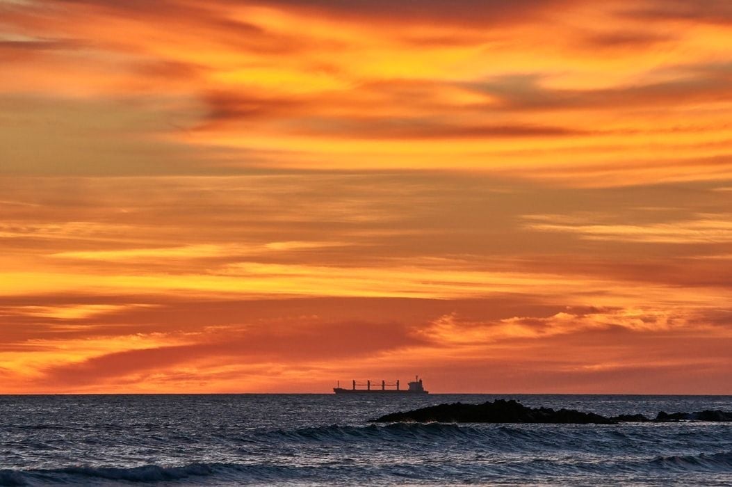 large vessel under orange sky