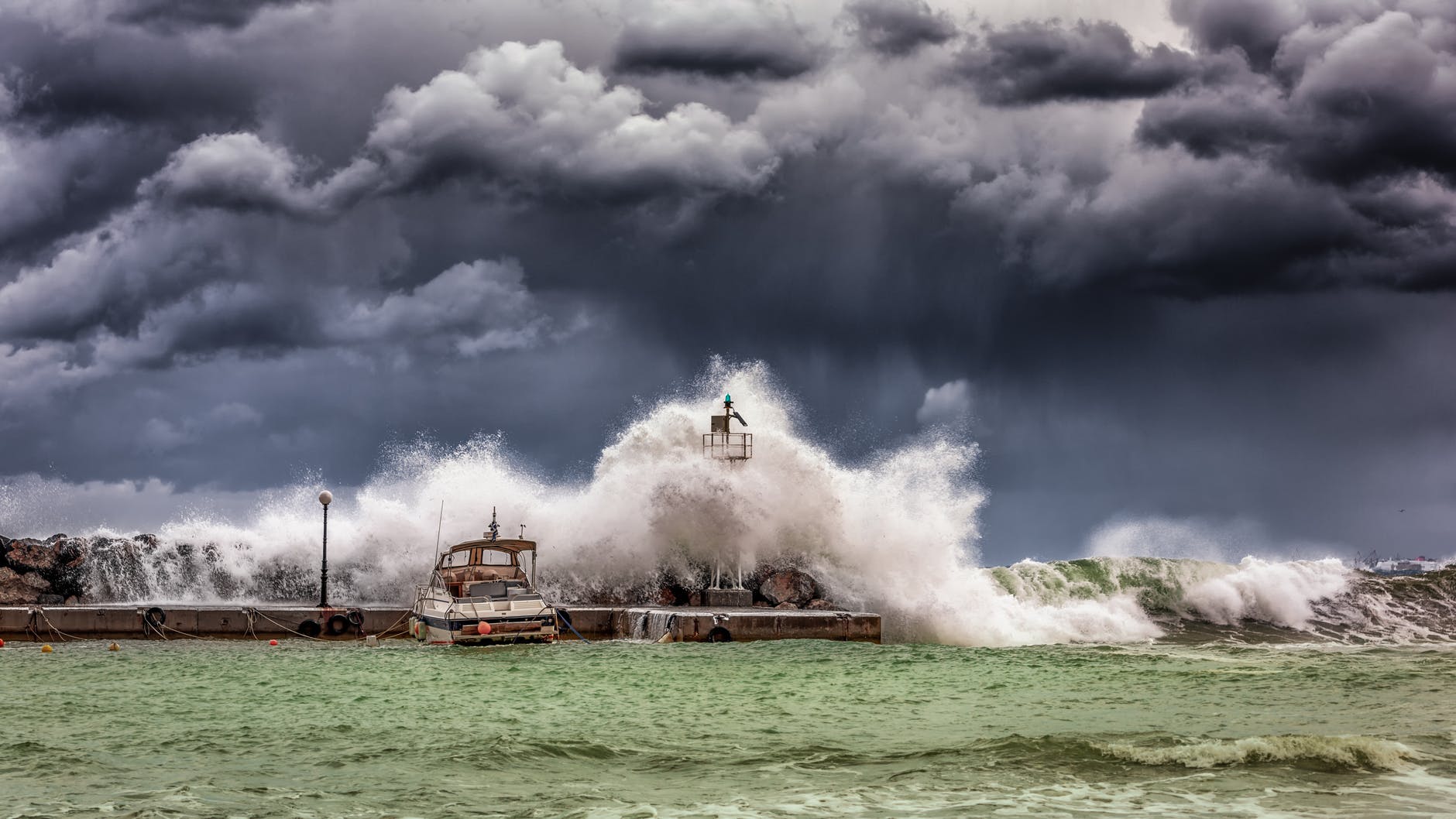 waves crashing on a harbor wall