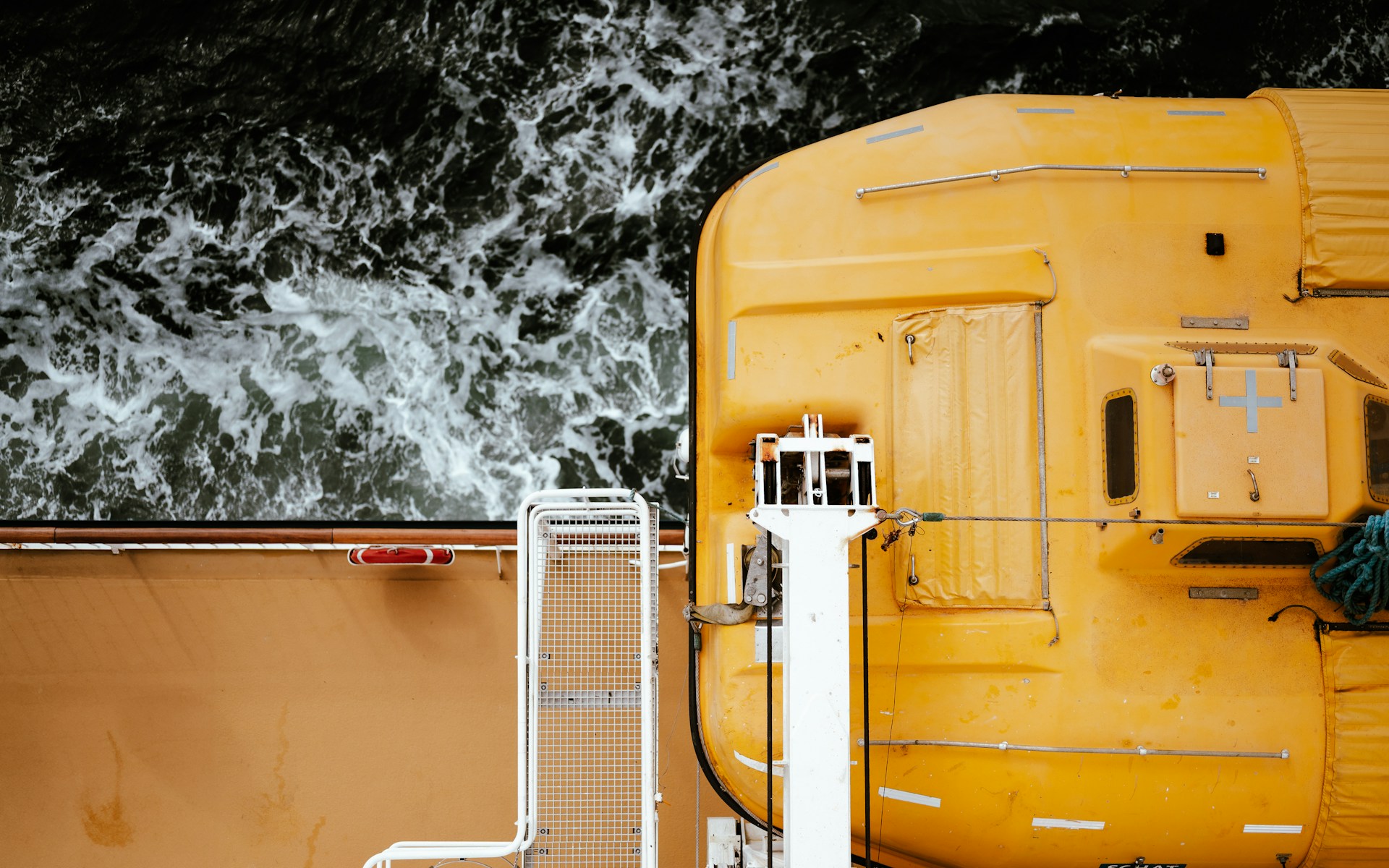 a yellow lifeboat in its davits