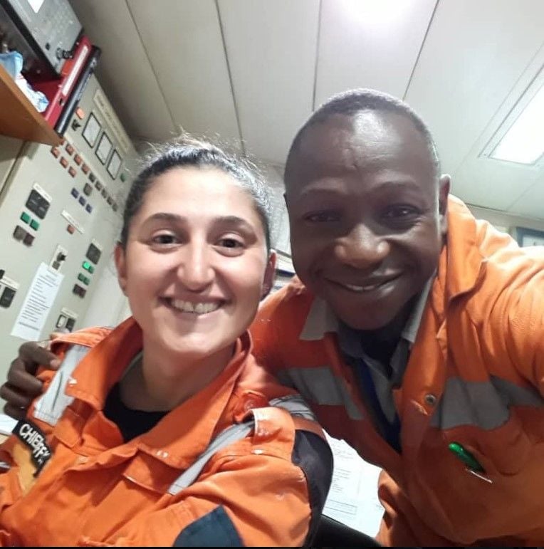 A smiling selfie taken by fellow crew members working in seafarer jobs