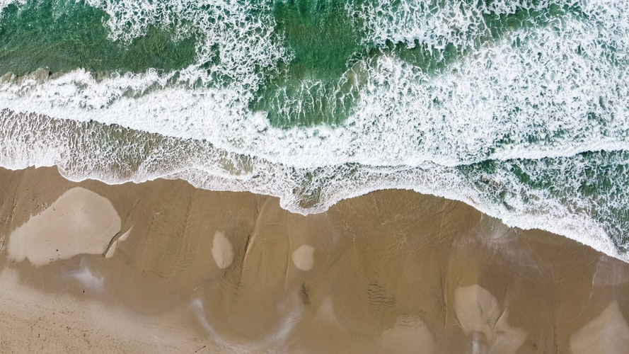 a smiley face drawn in sand