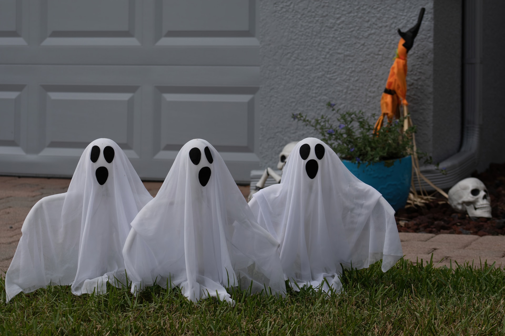 3 Halloween ghost ornaments in a garden