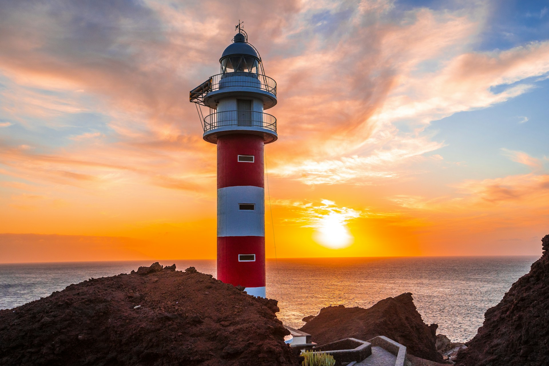 a lighthouse at sunset