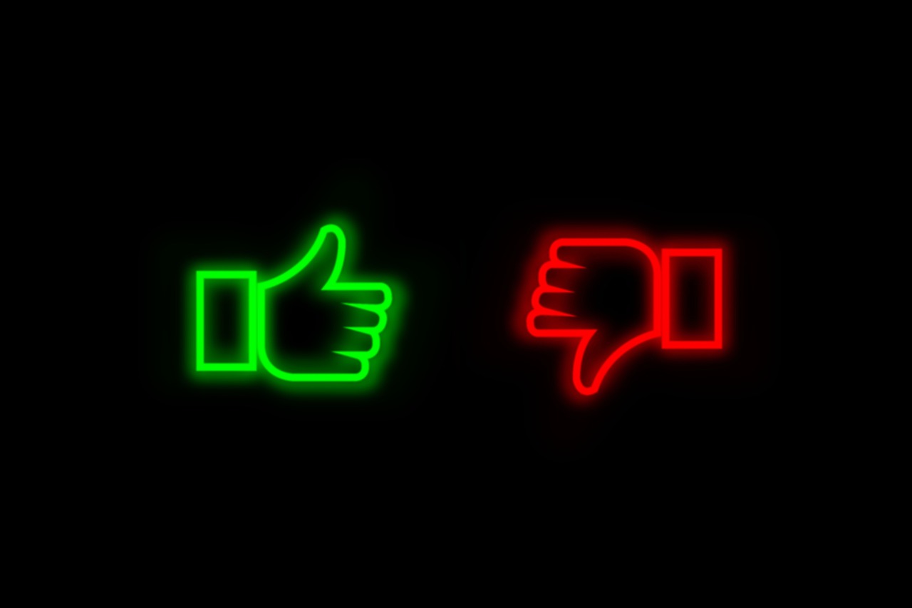 a green neon thumbs up and a red neon thumbs down