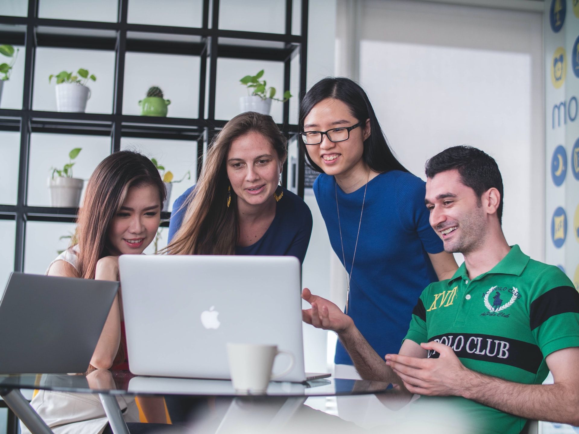 coworkers looking at laptop