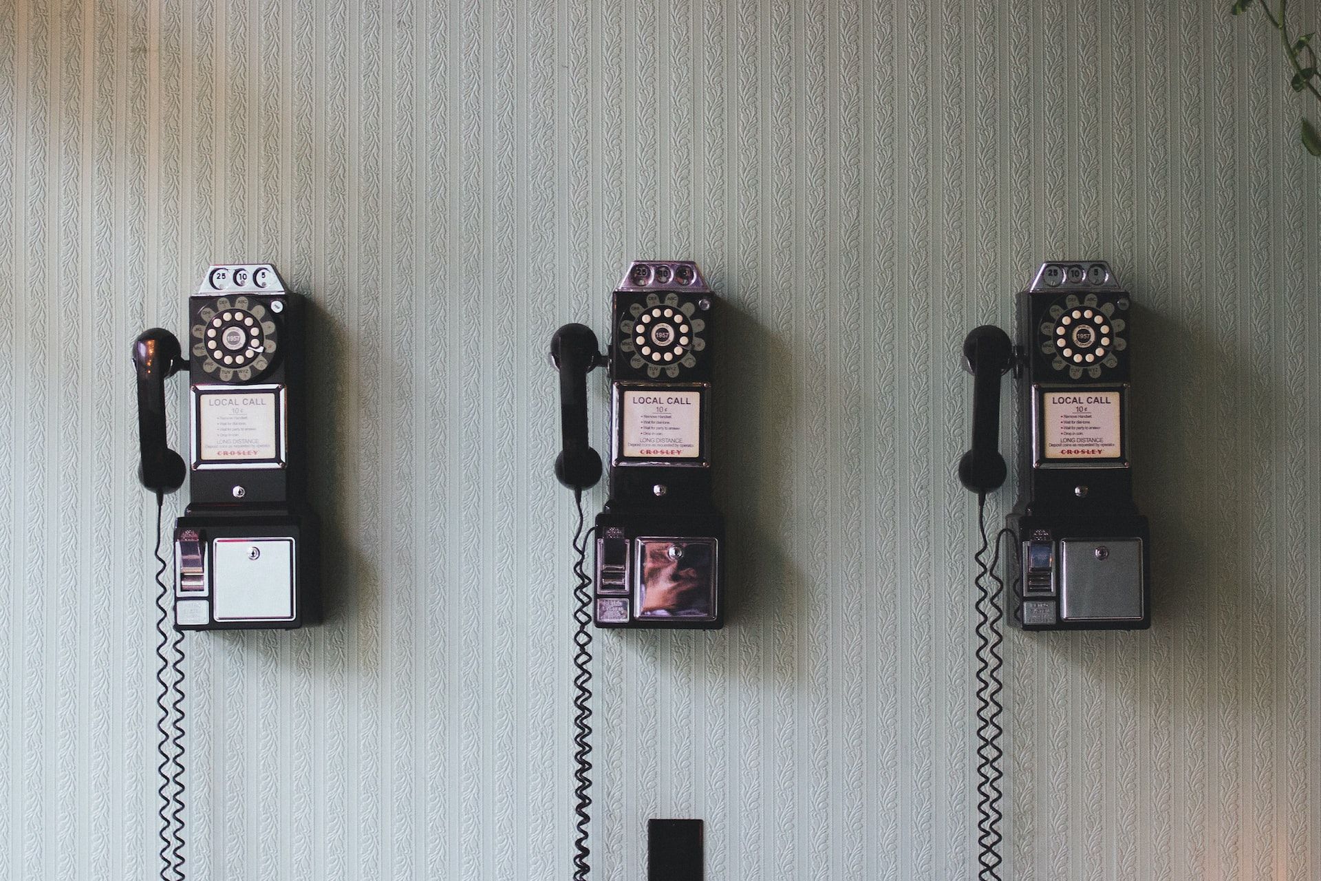 3 old fashioned wall mounted phones