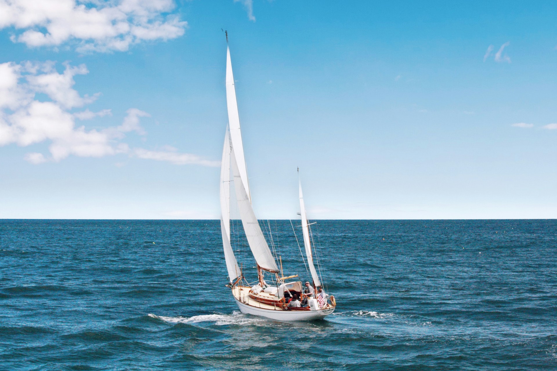 a small sailboat at sea