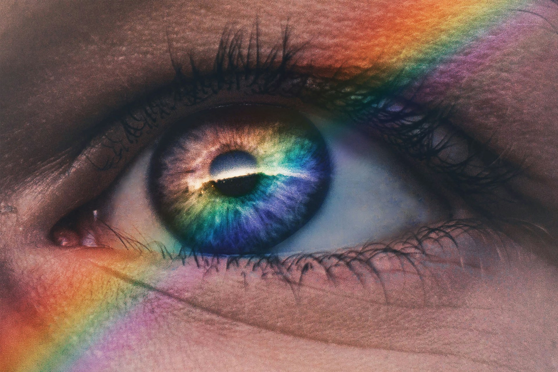An eye with a rainbow superimposed over it