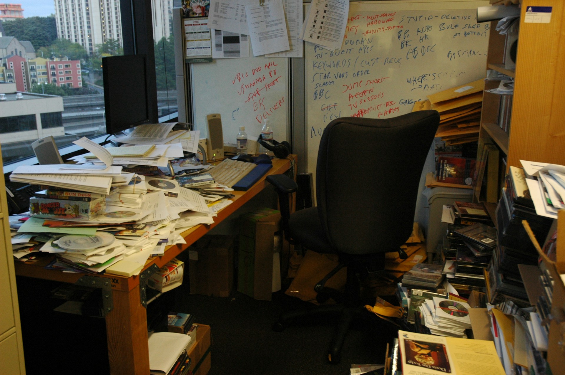 A messy office covered in piles of paper
