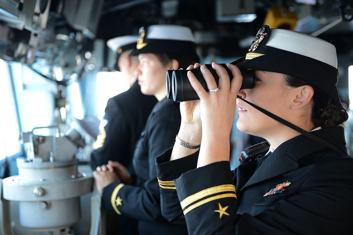 female seafarer looking through binnoculars 