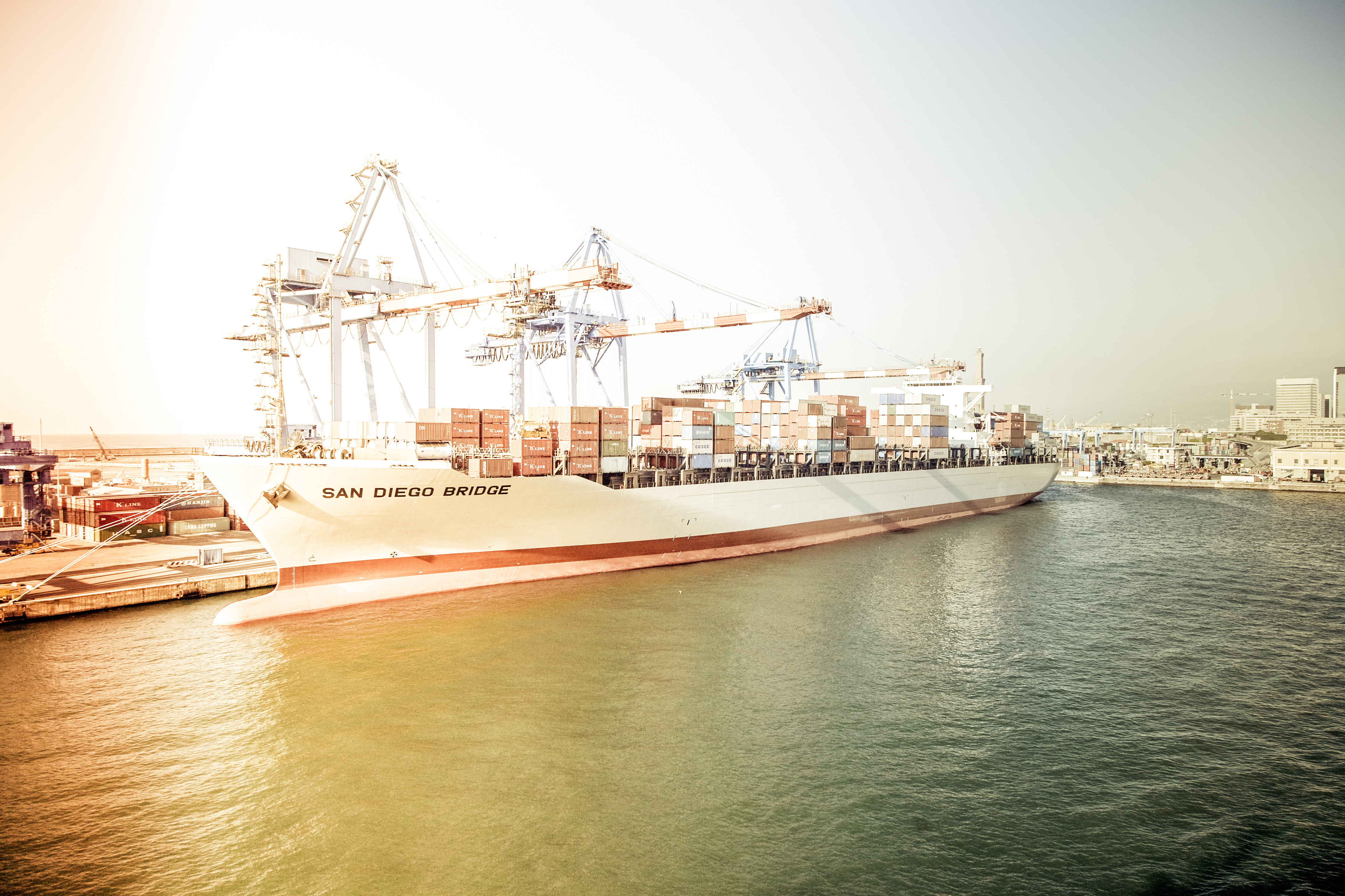 a container ship at golden hour in a port