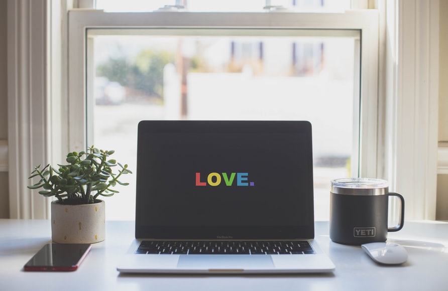 a laptop with the word 'love' on the screen