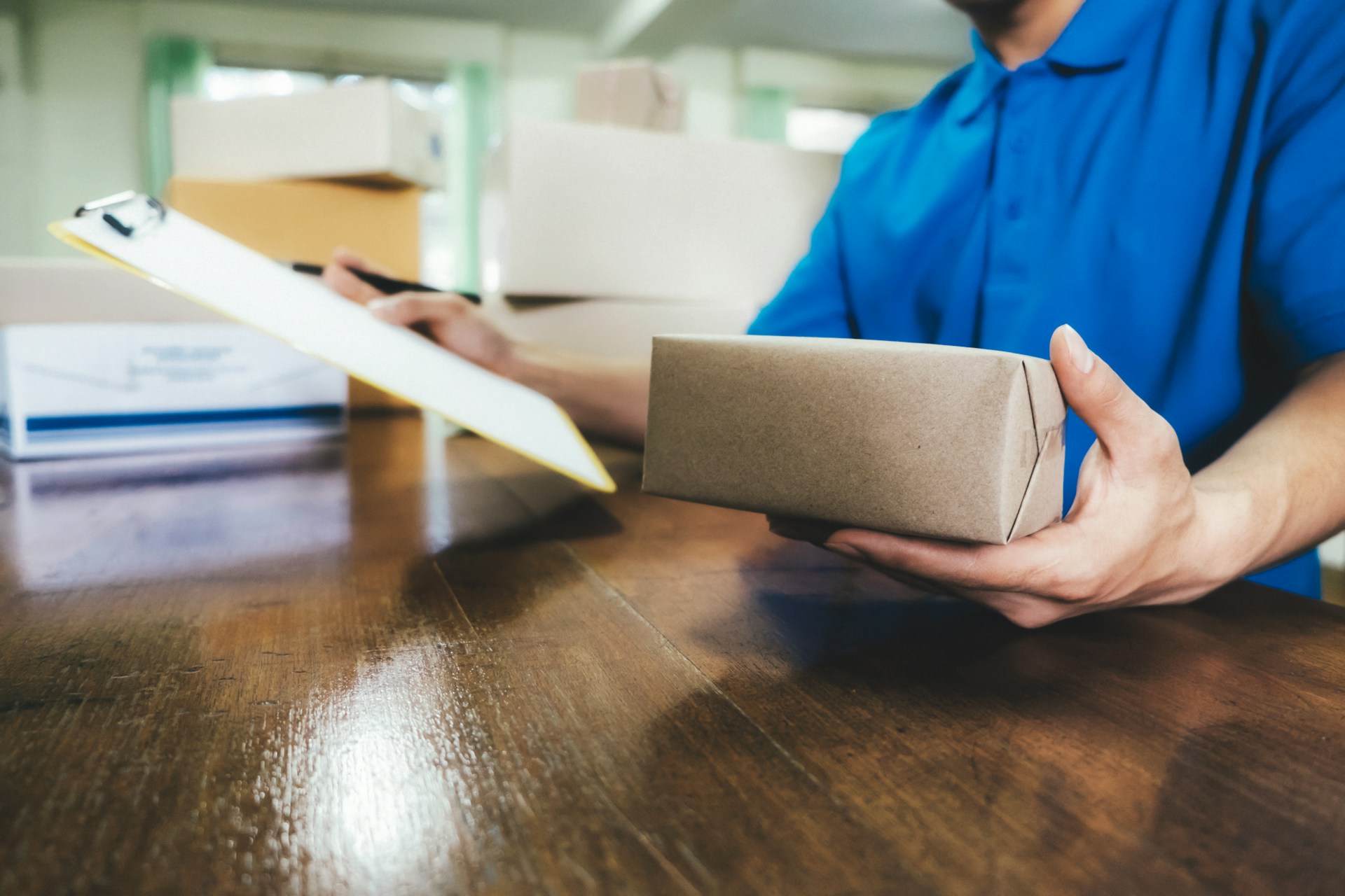 a man holding a brown paper parcel