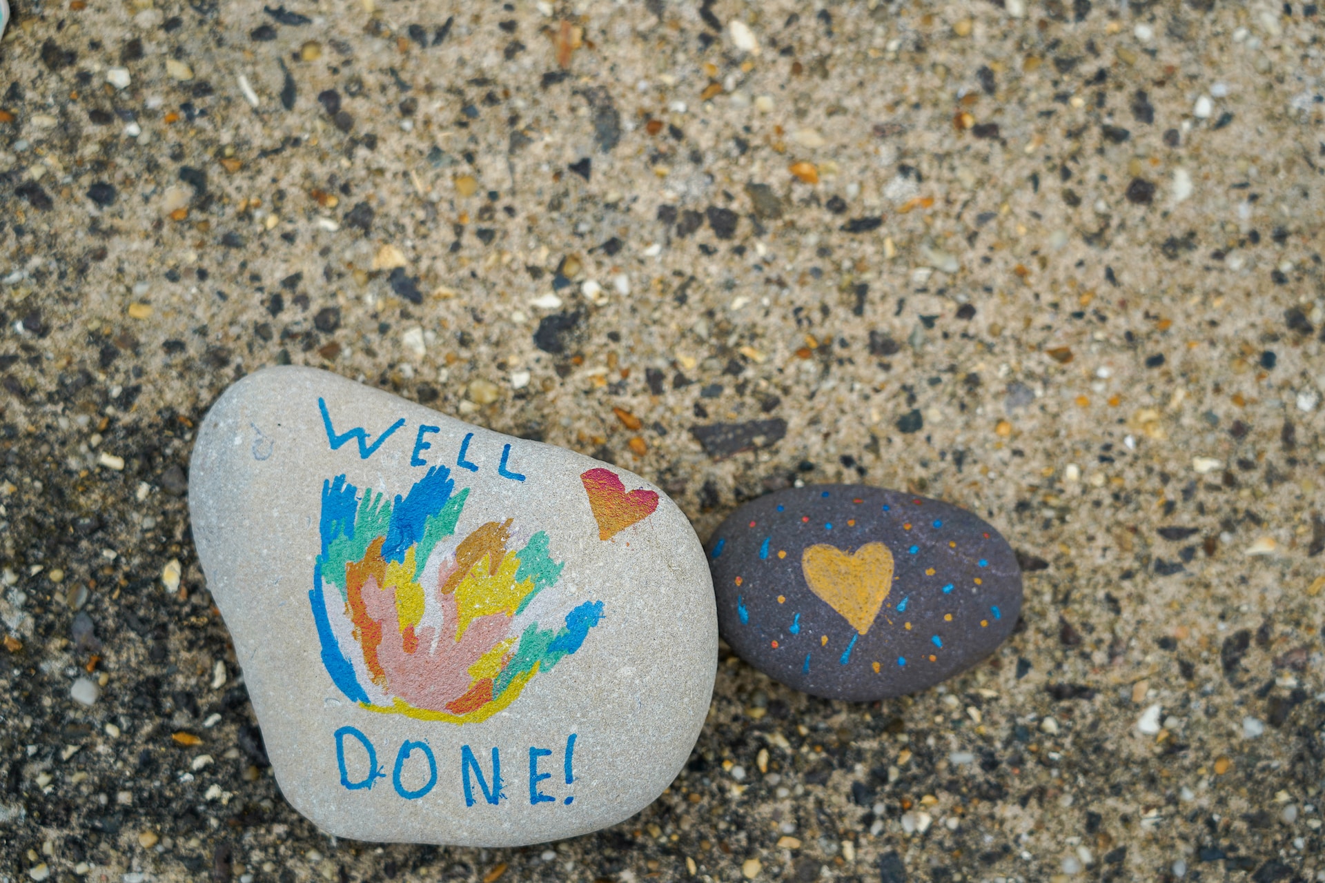 well done and a heart painted on a pebble