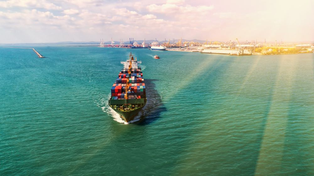 a container ship heading away from port