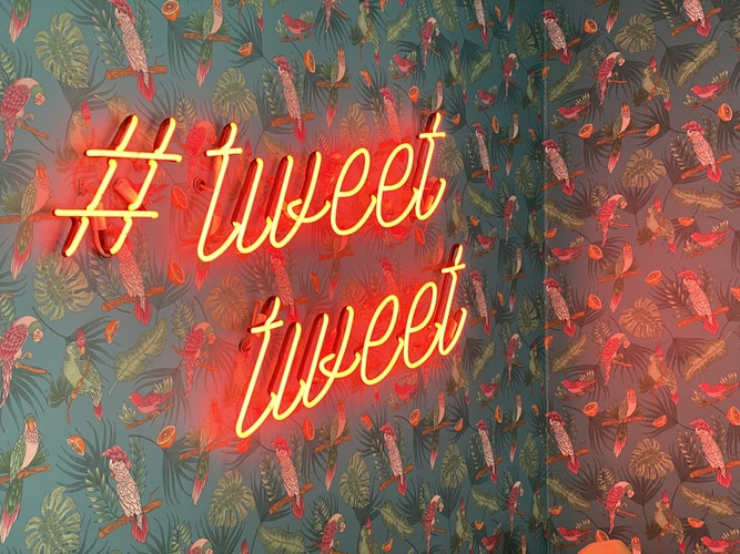 neon sign saying #tweet tweet