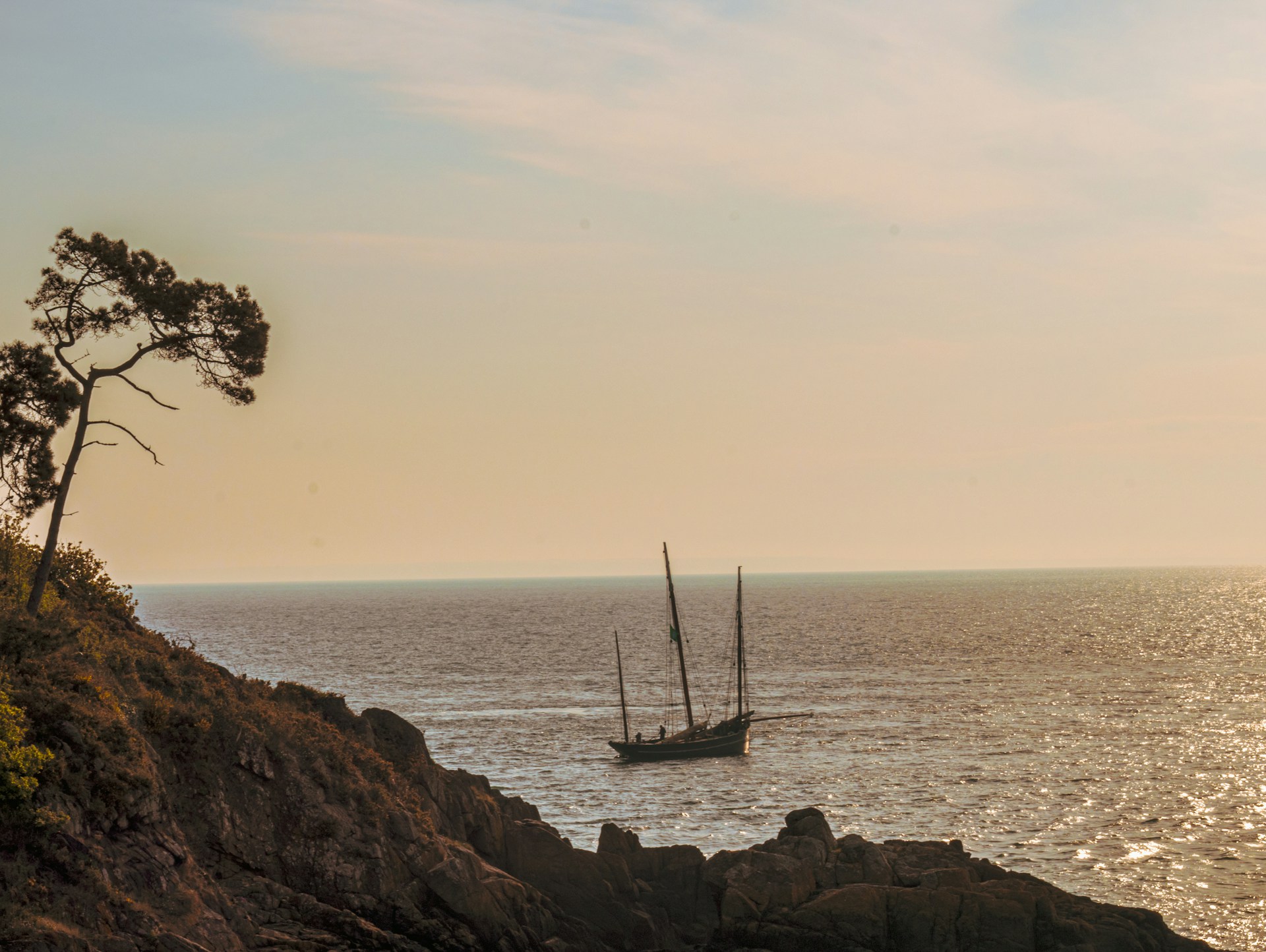 A sailing vessel with no visible crew at sea