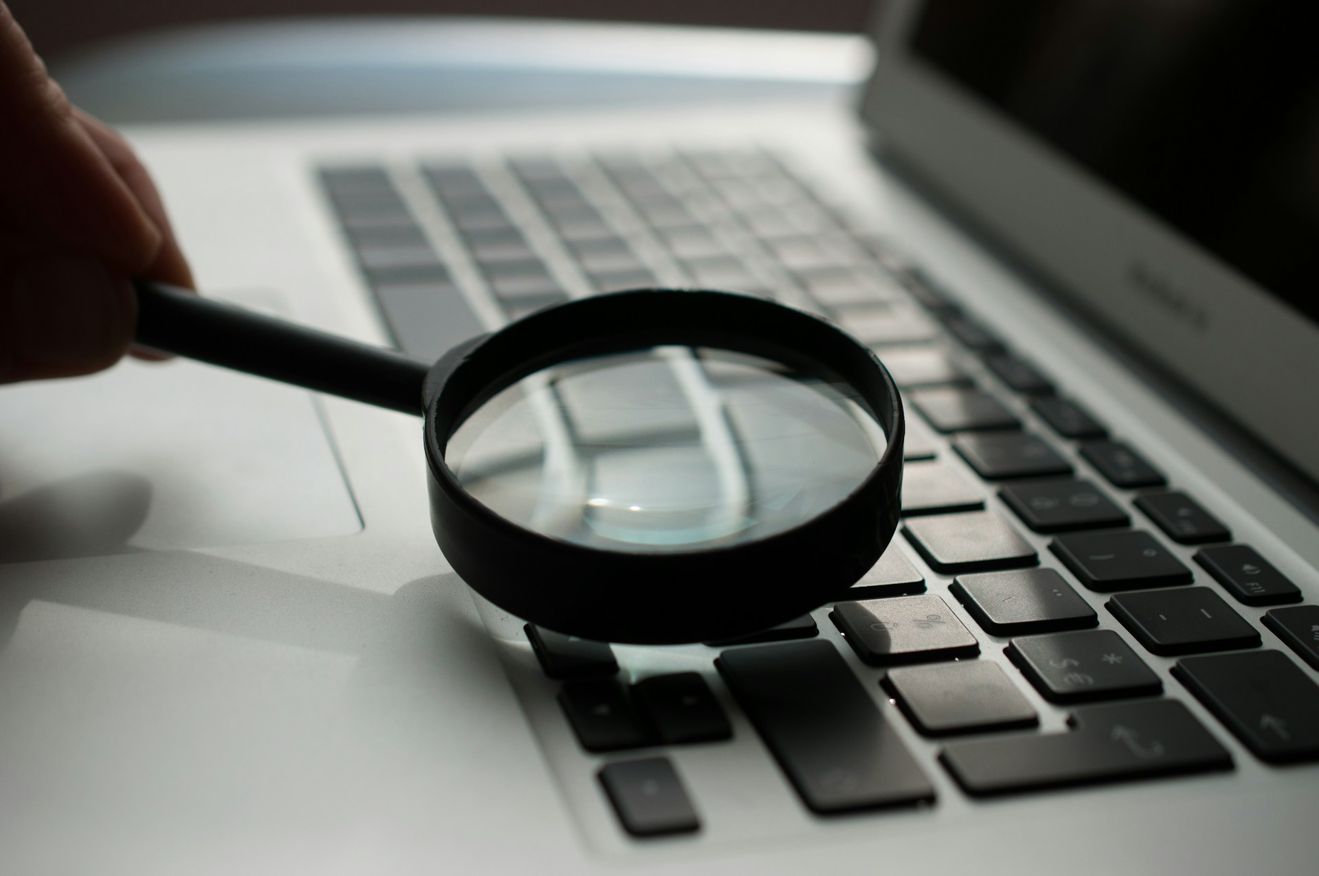 a magnifying glass on a laptop keyboard