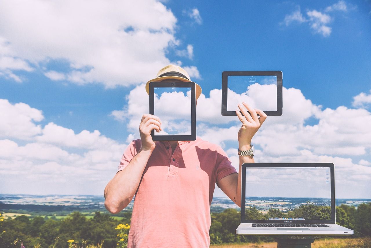 man holding frames over clouds