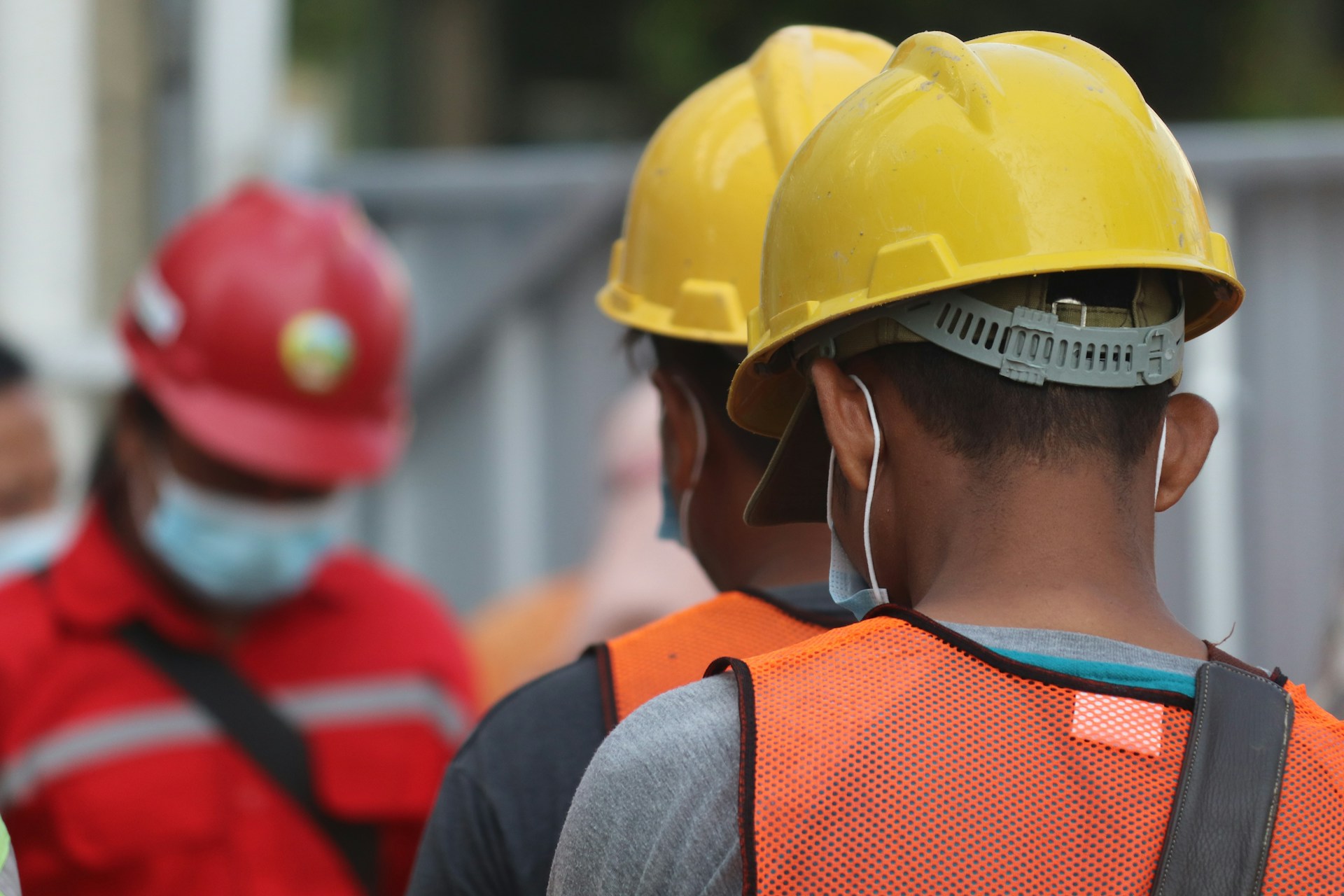 Men wearing safety helmets and hi-vis clothing