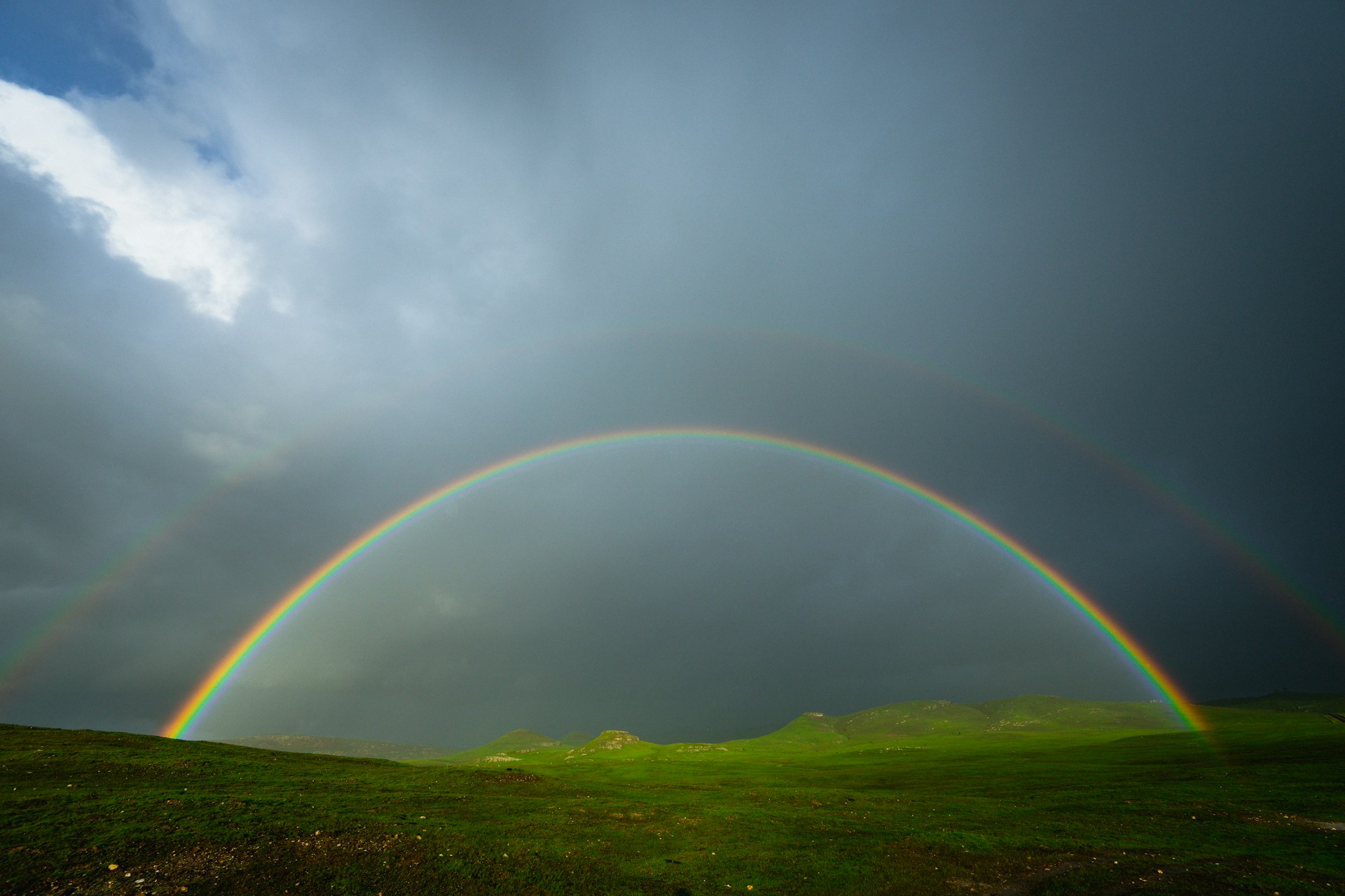 a rainbow over hills