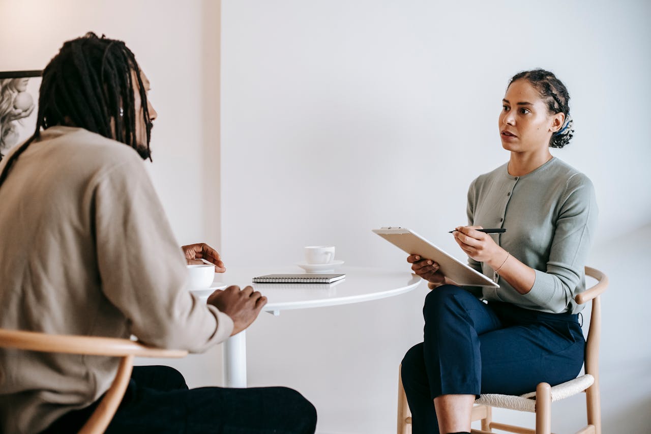 a woman listening to a man while she interviews him for a job