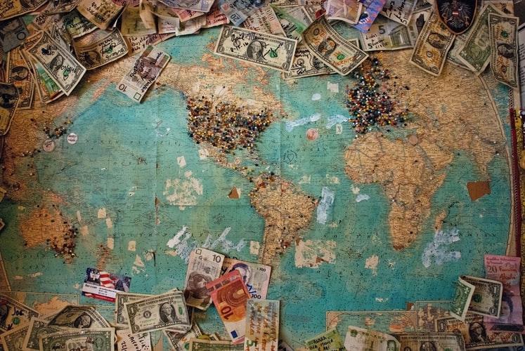 a map of the world and bank notes