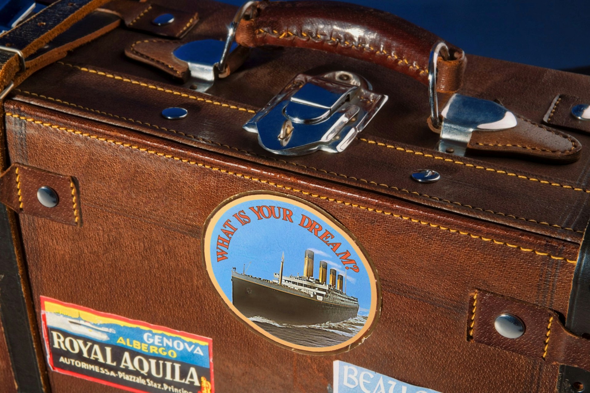 a suitcase with vintage travels stickers on it