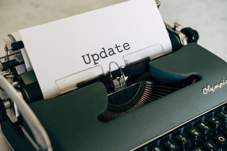 typewriter with paper saying update