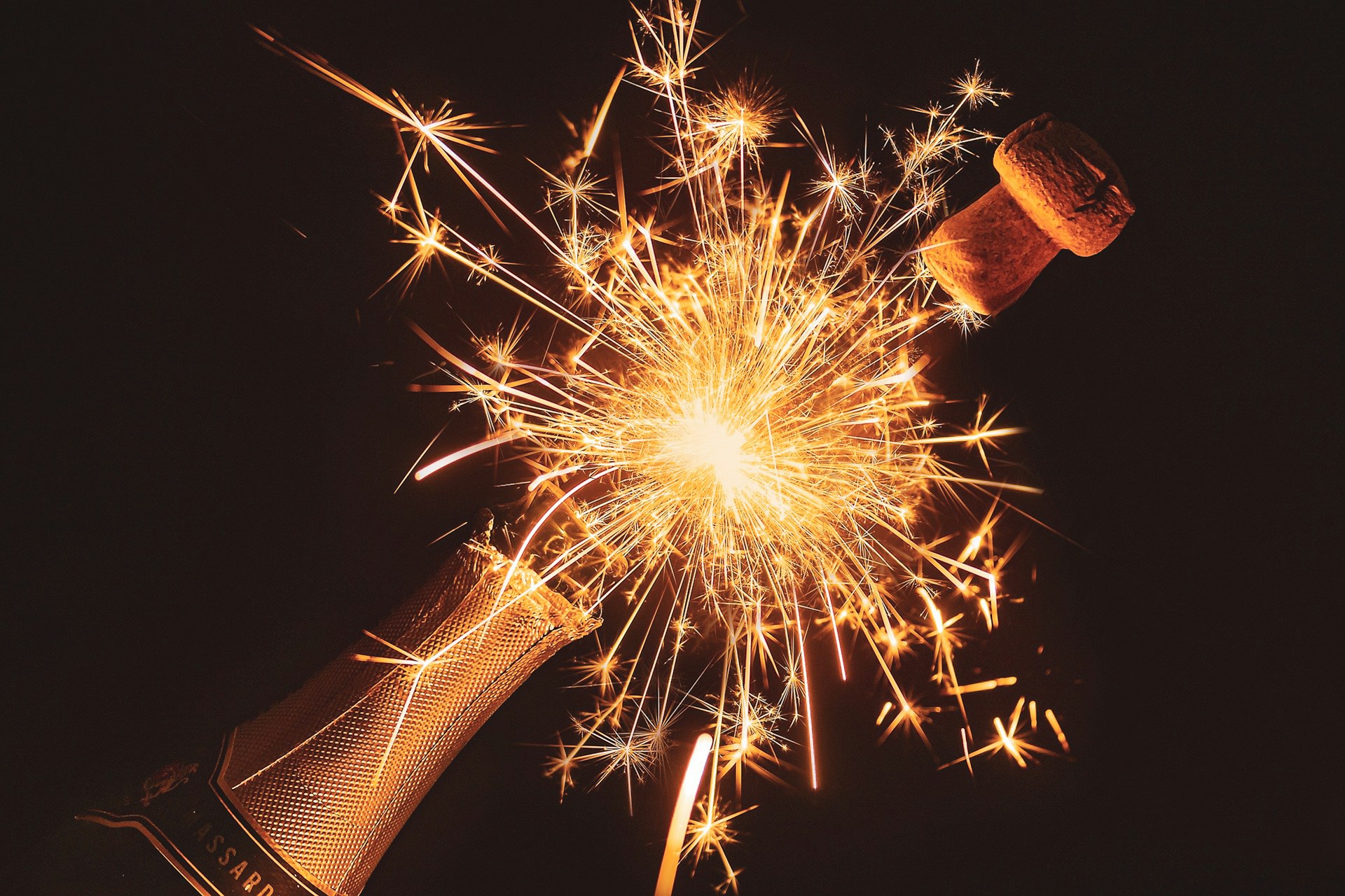 a champagne bottle with sparklers coming out of it