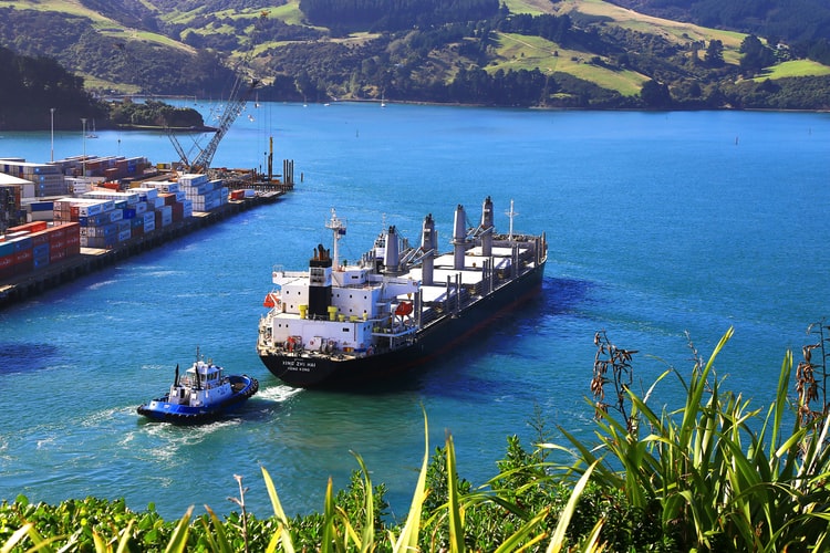 a bulk carrier and tug approaching port