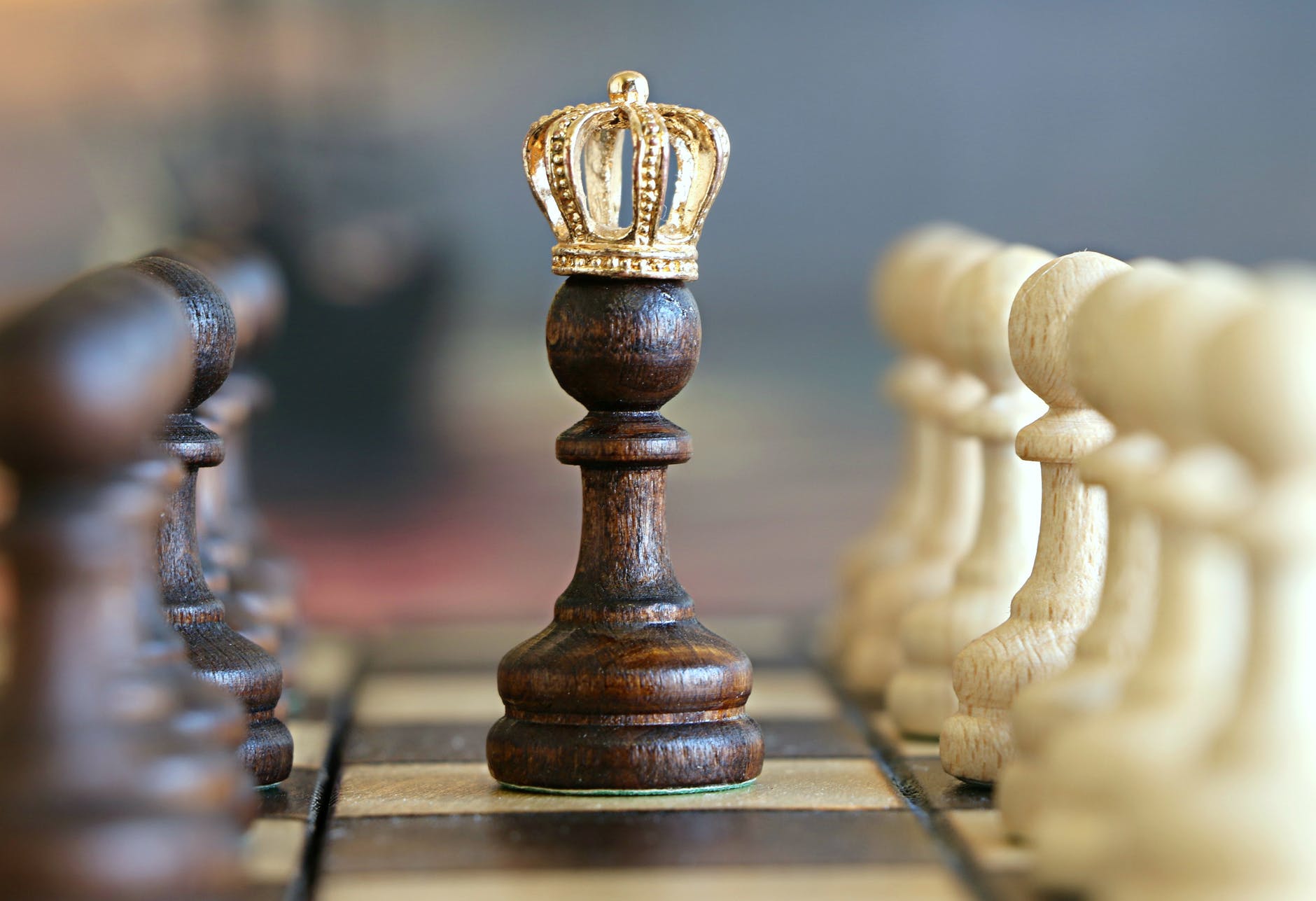pawn chess piece wearing a crown