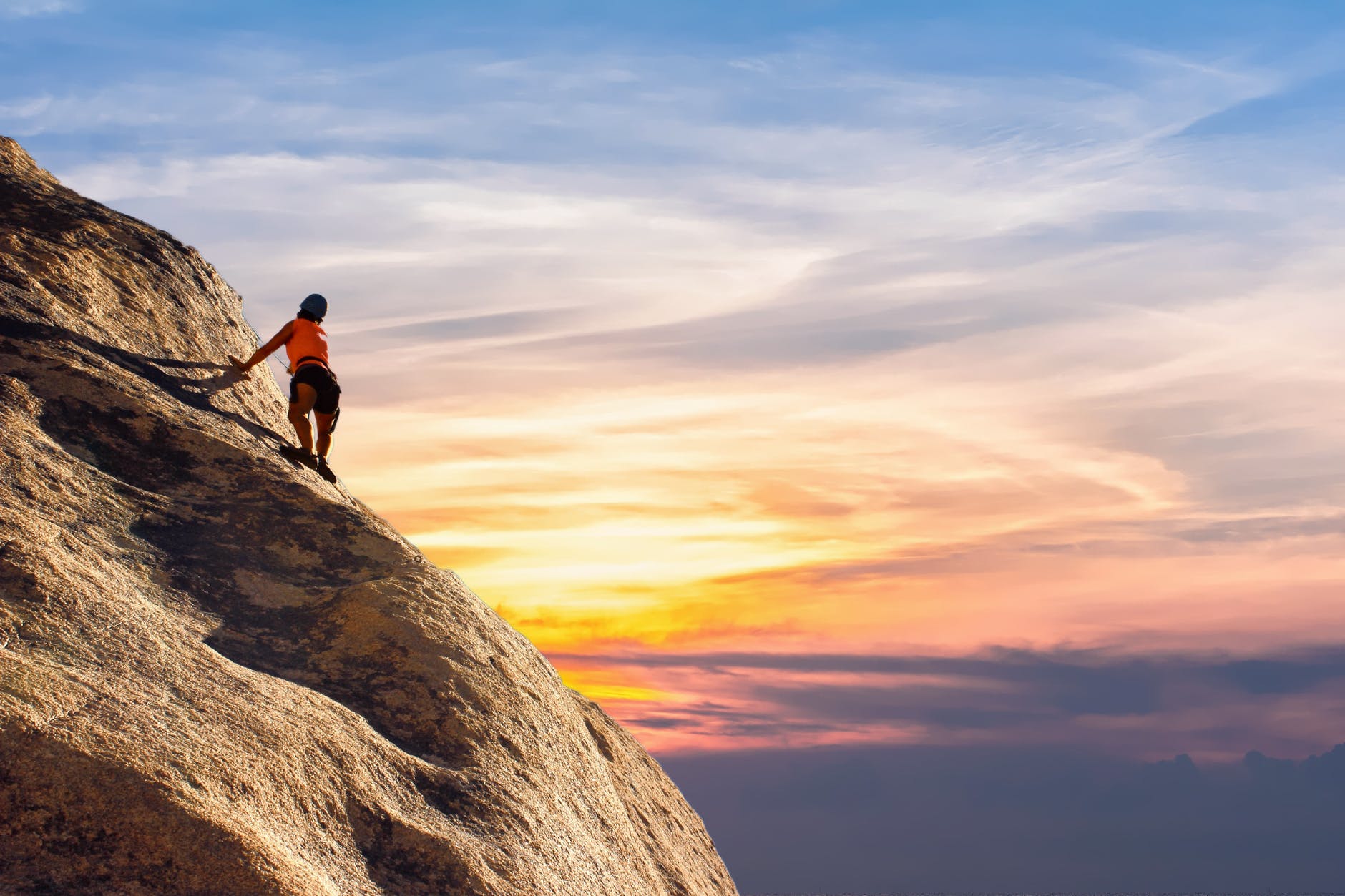 person climbing up mountain