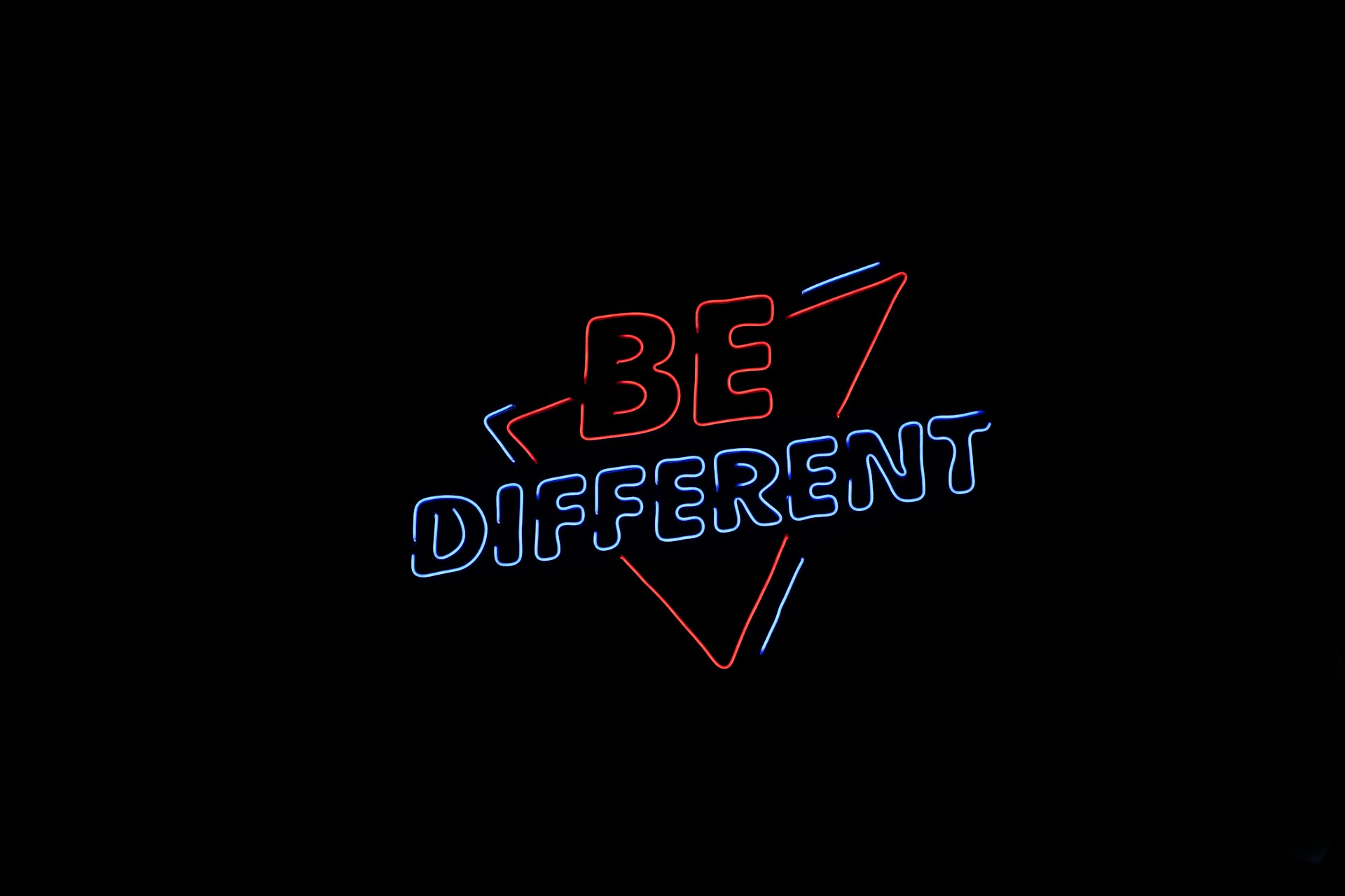 Neon sign saying 'be different'