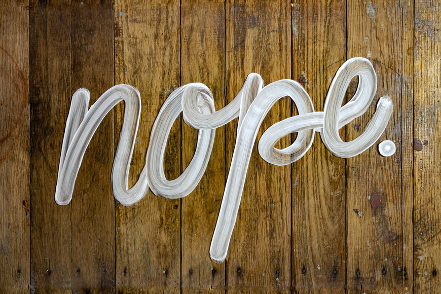 the word 'nope' painted on wood