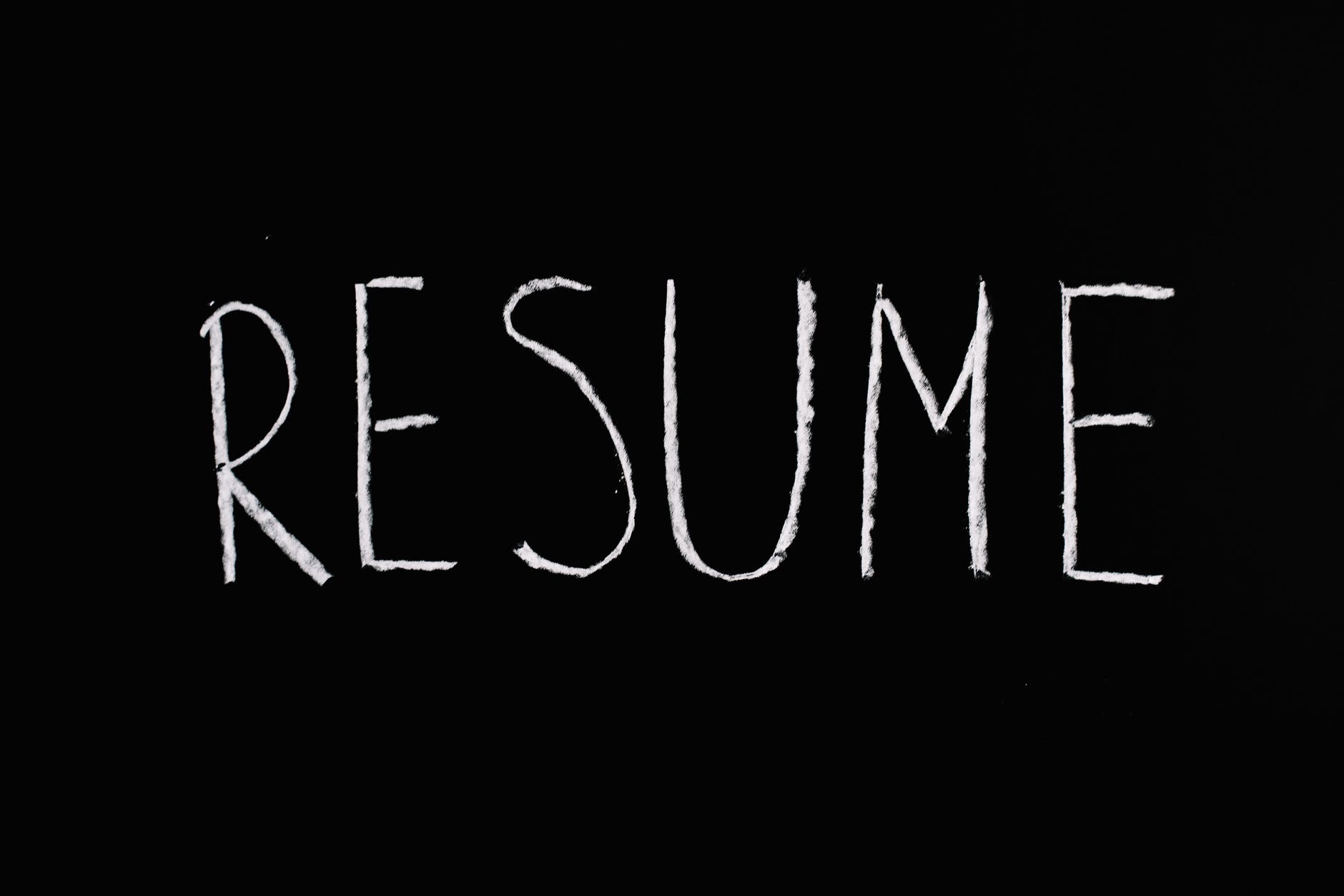 the word resume written on a chalkboard