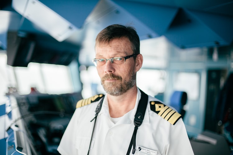 a ship's master working on the bridge of a ship