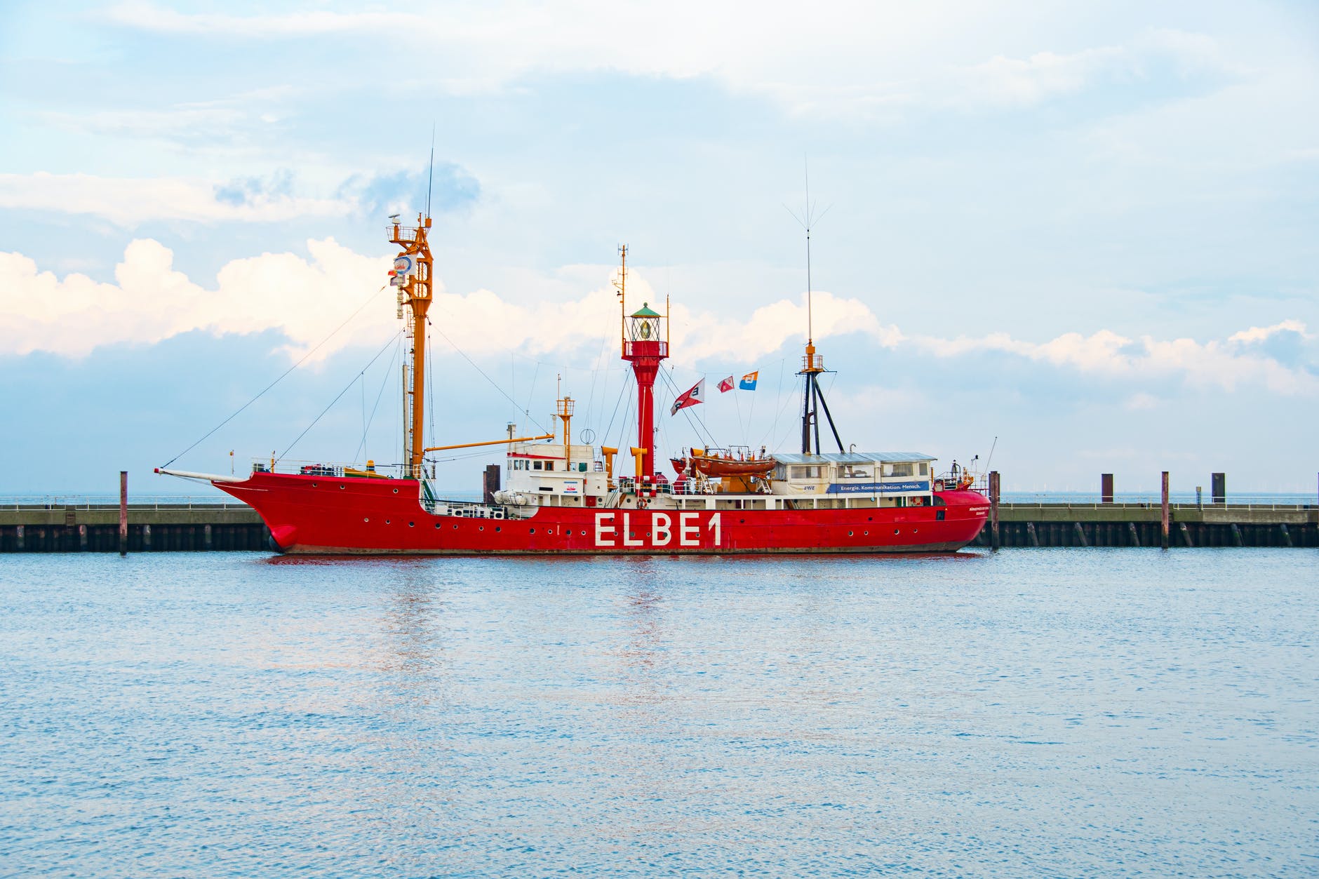 a lightship docked at a pier