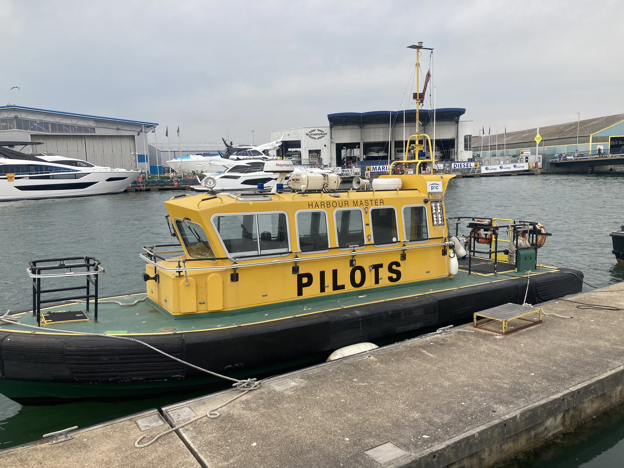 a yellow pilot boat in a harbor