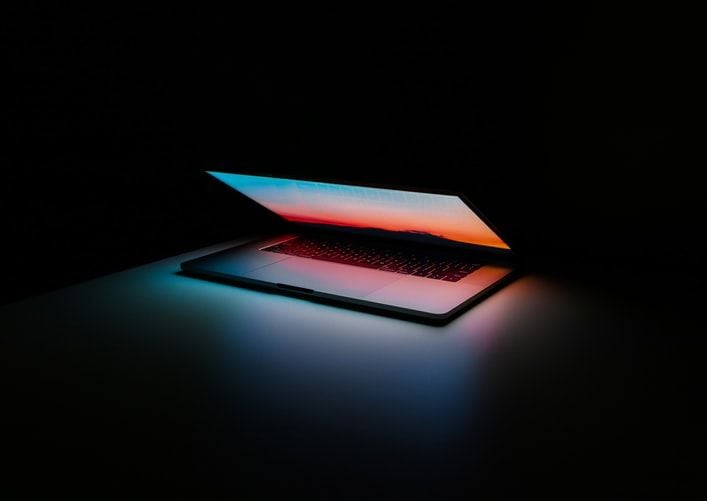 slightly open glowing laptop