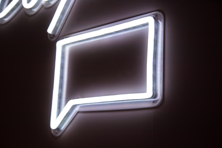 A white neon message icon