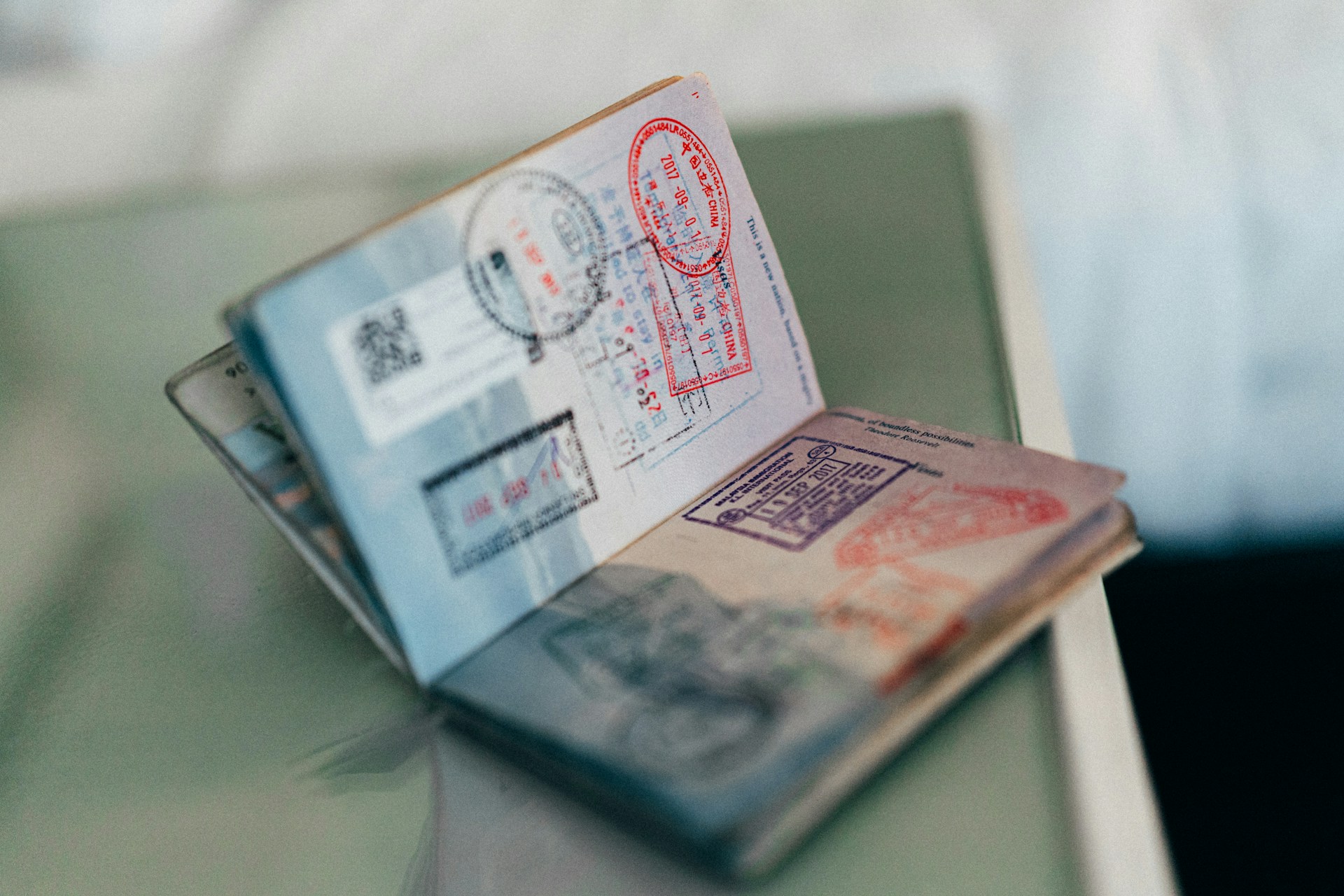 an open passport showing visa stamps