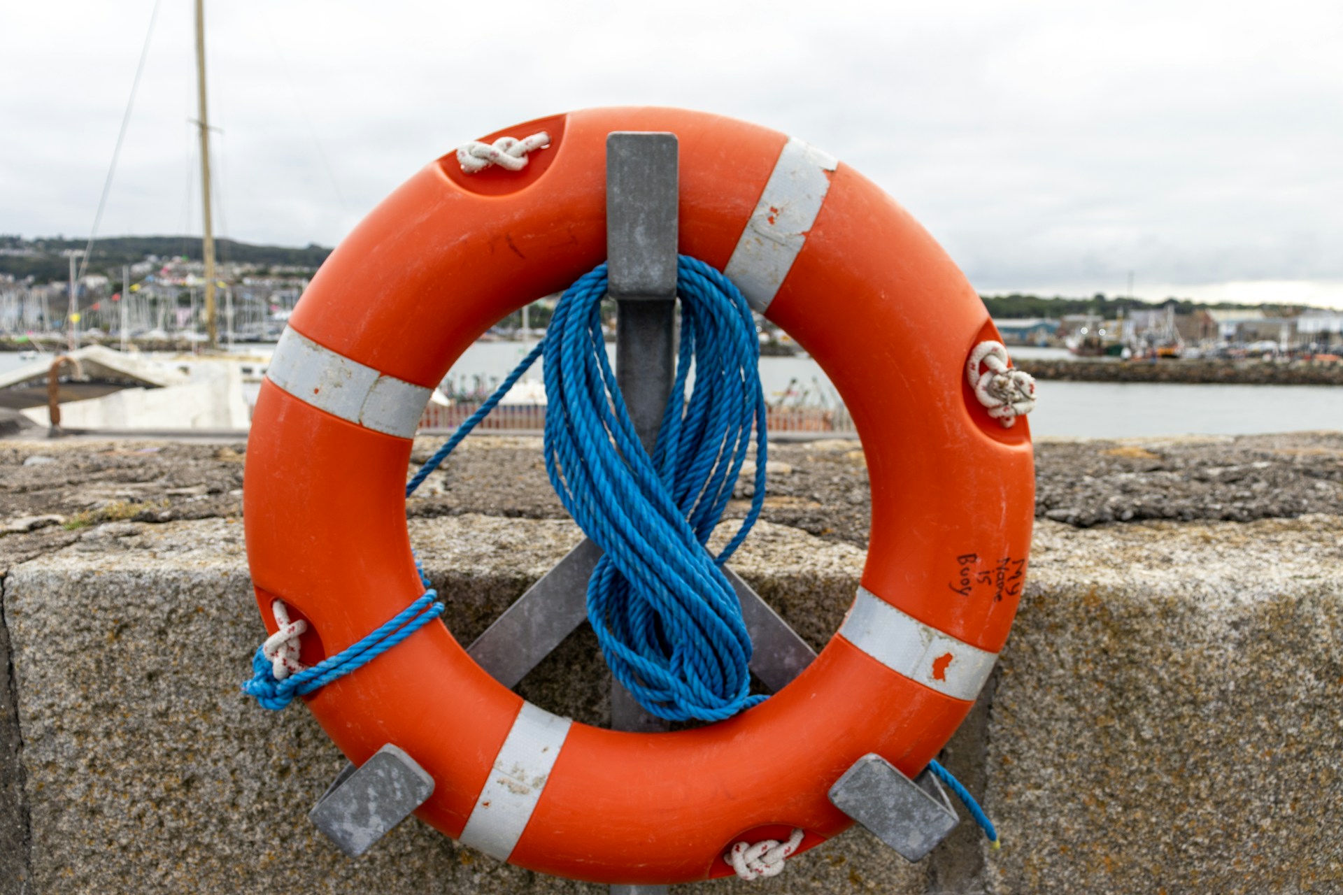 a life buoy mounted on a sea wall