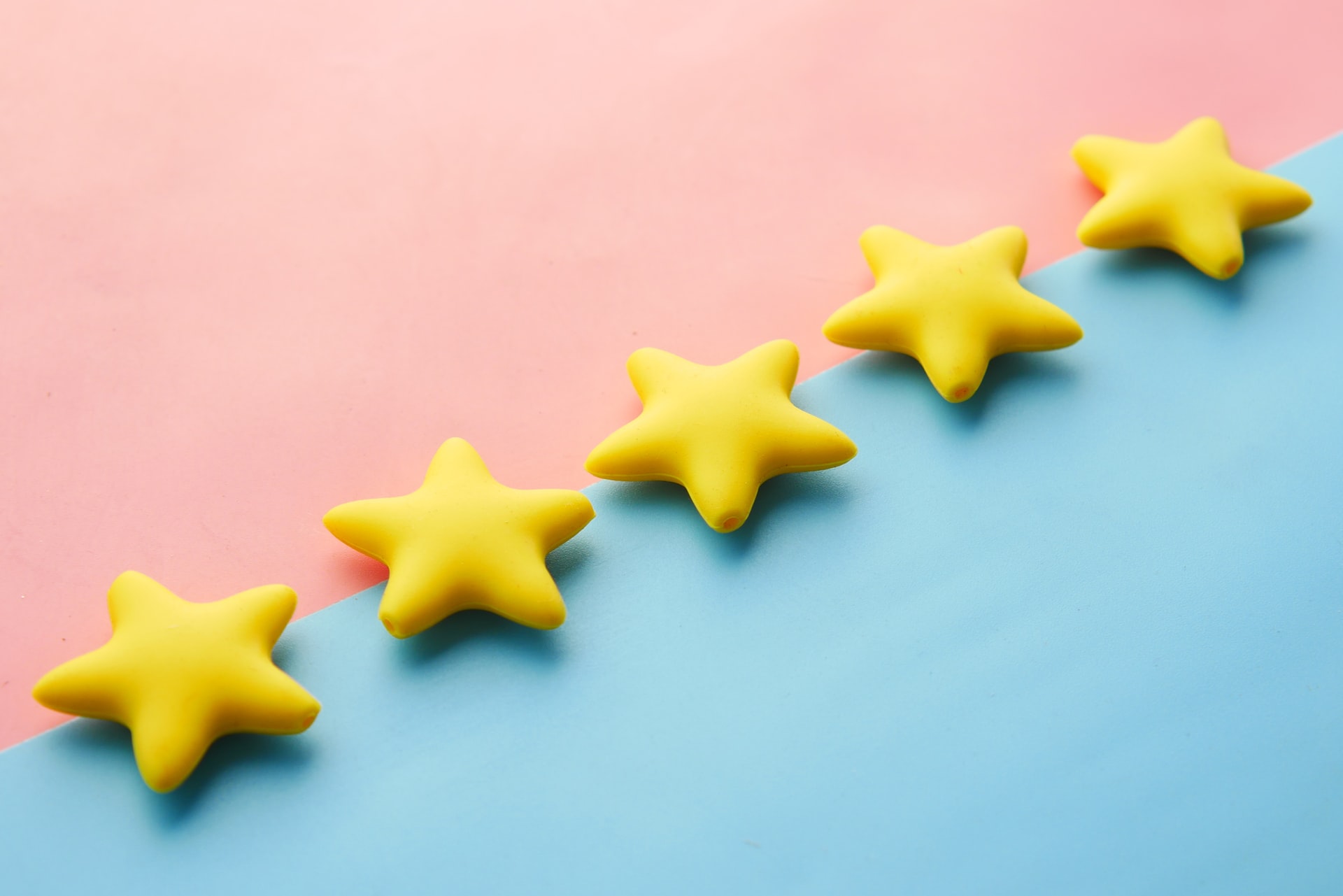 5 yellow stars on a pink and blue background