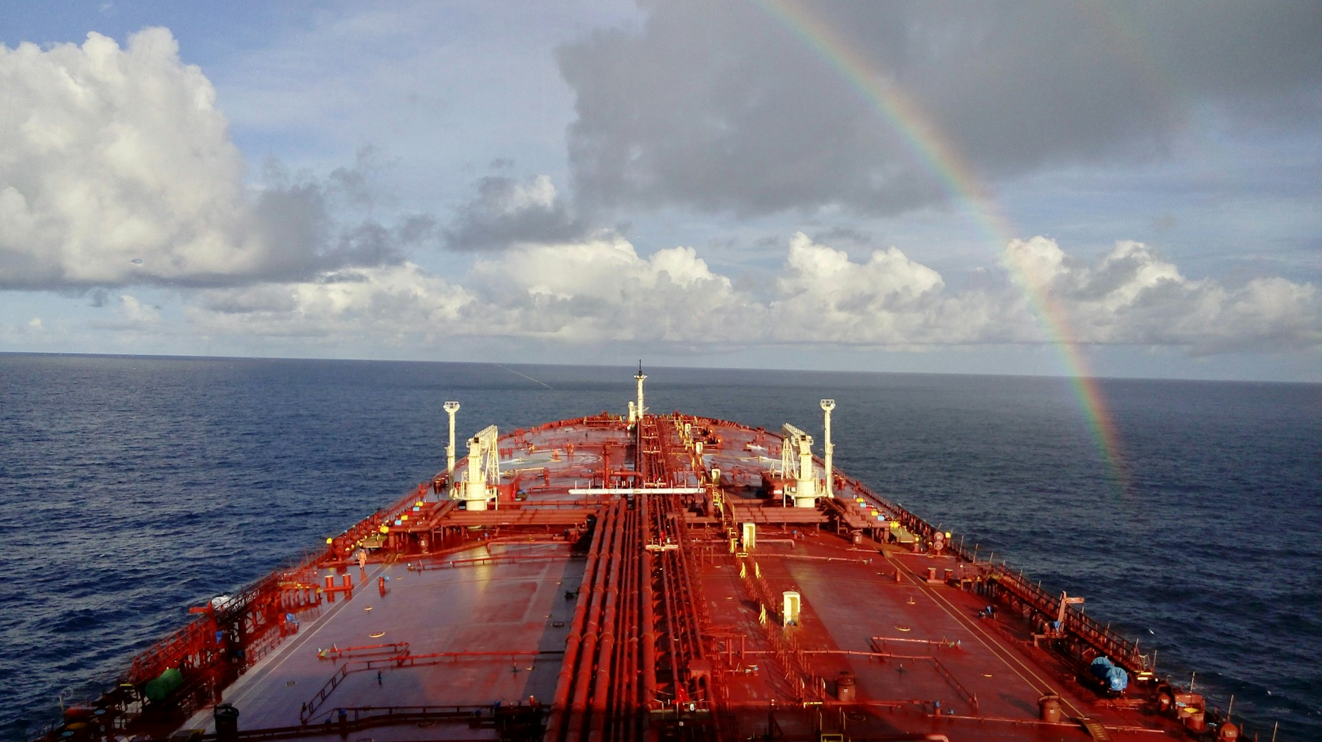 the view from the bridge on a chemical tanker as it sails towards a rainbow