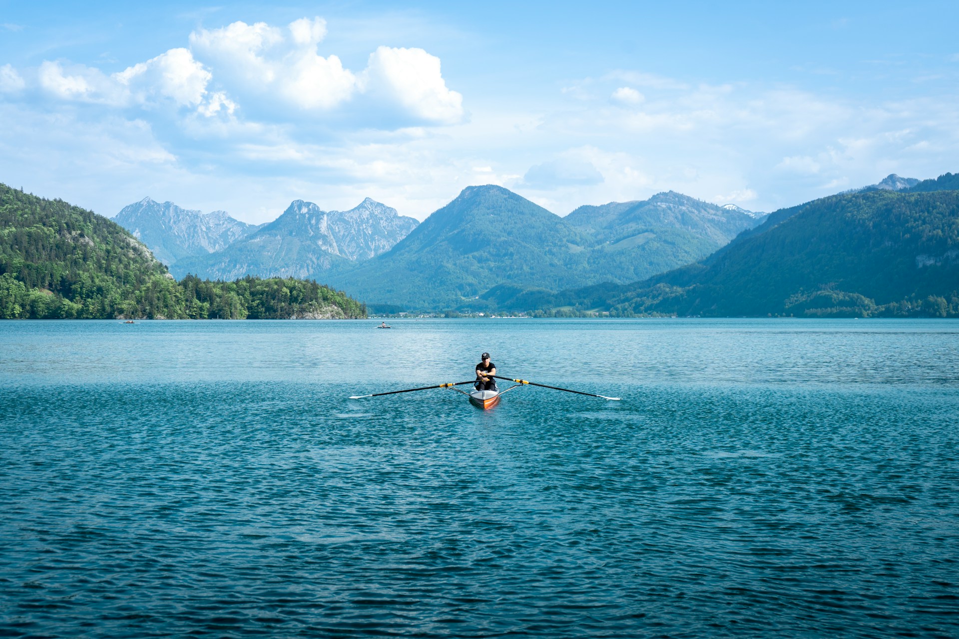 a person rowing a boat on a lake