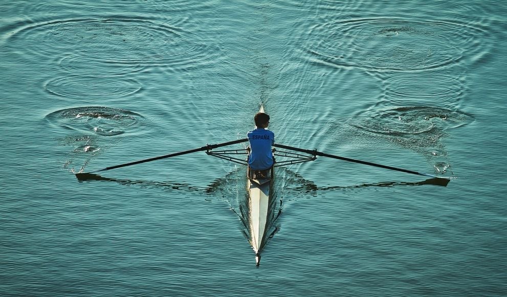 person rowing canoe