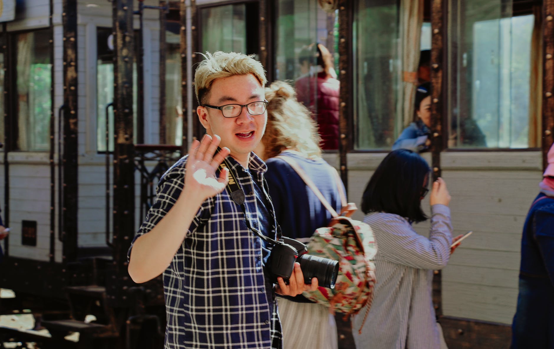 a young man waving goodbye