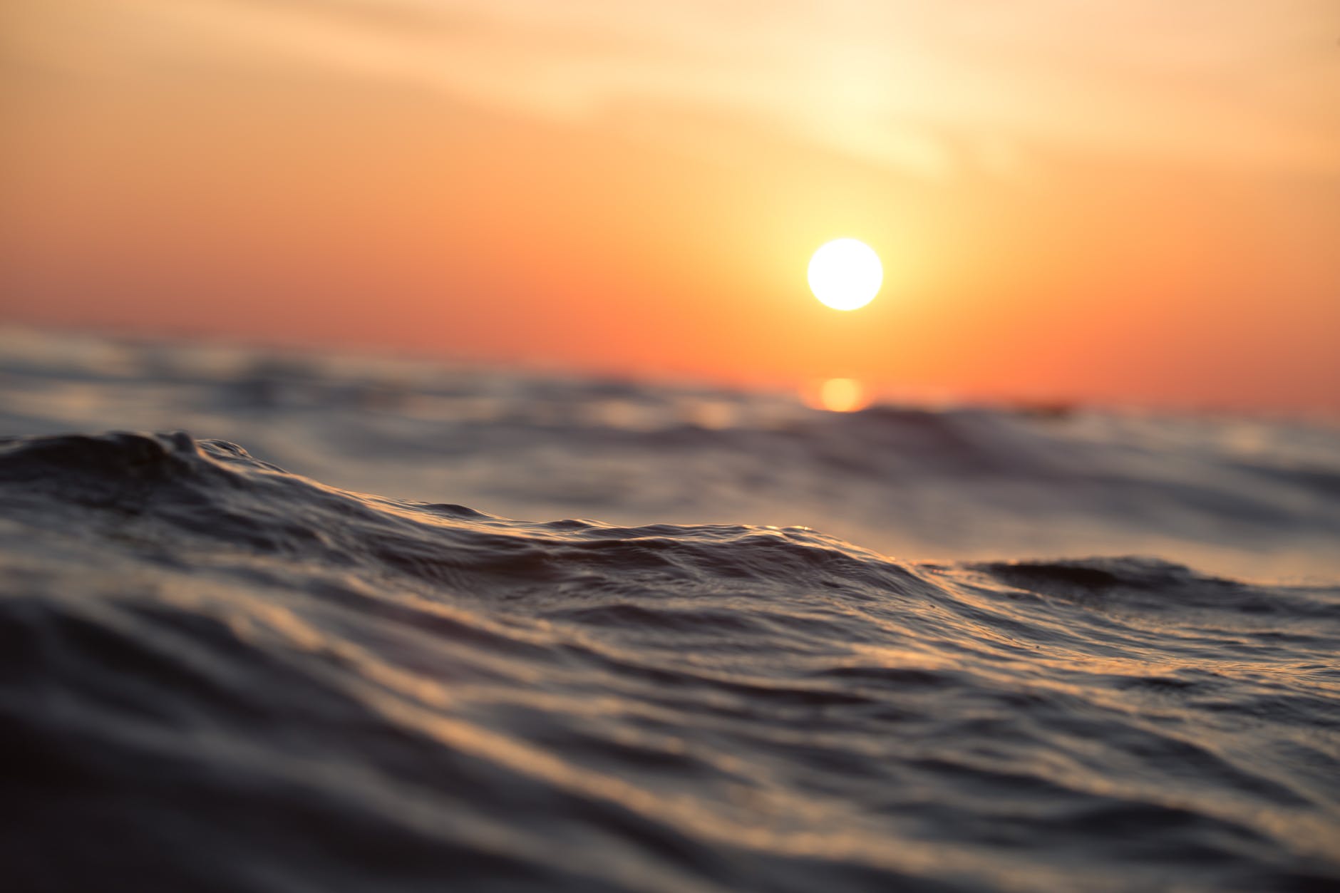 a choppy sea at sunset