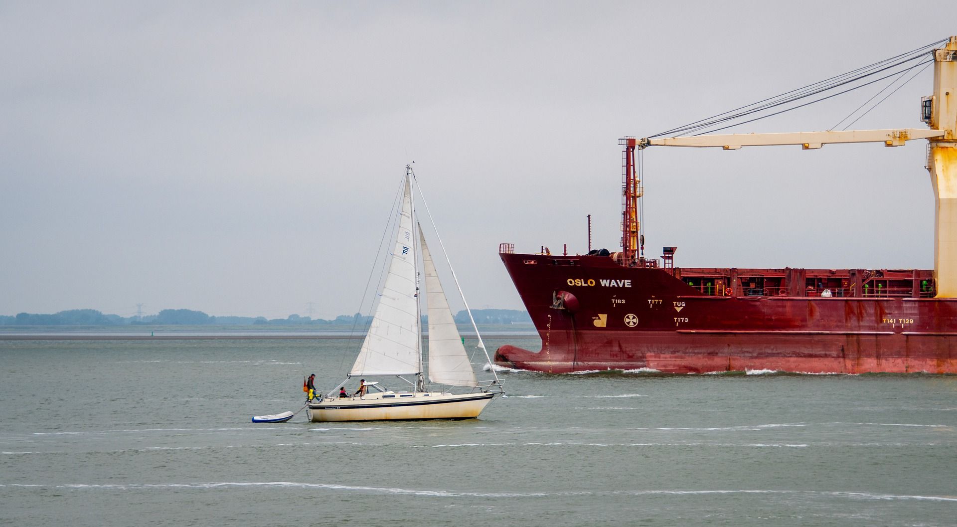 sailboat and bulk carrier